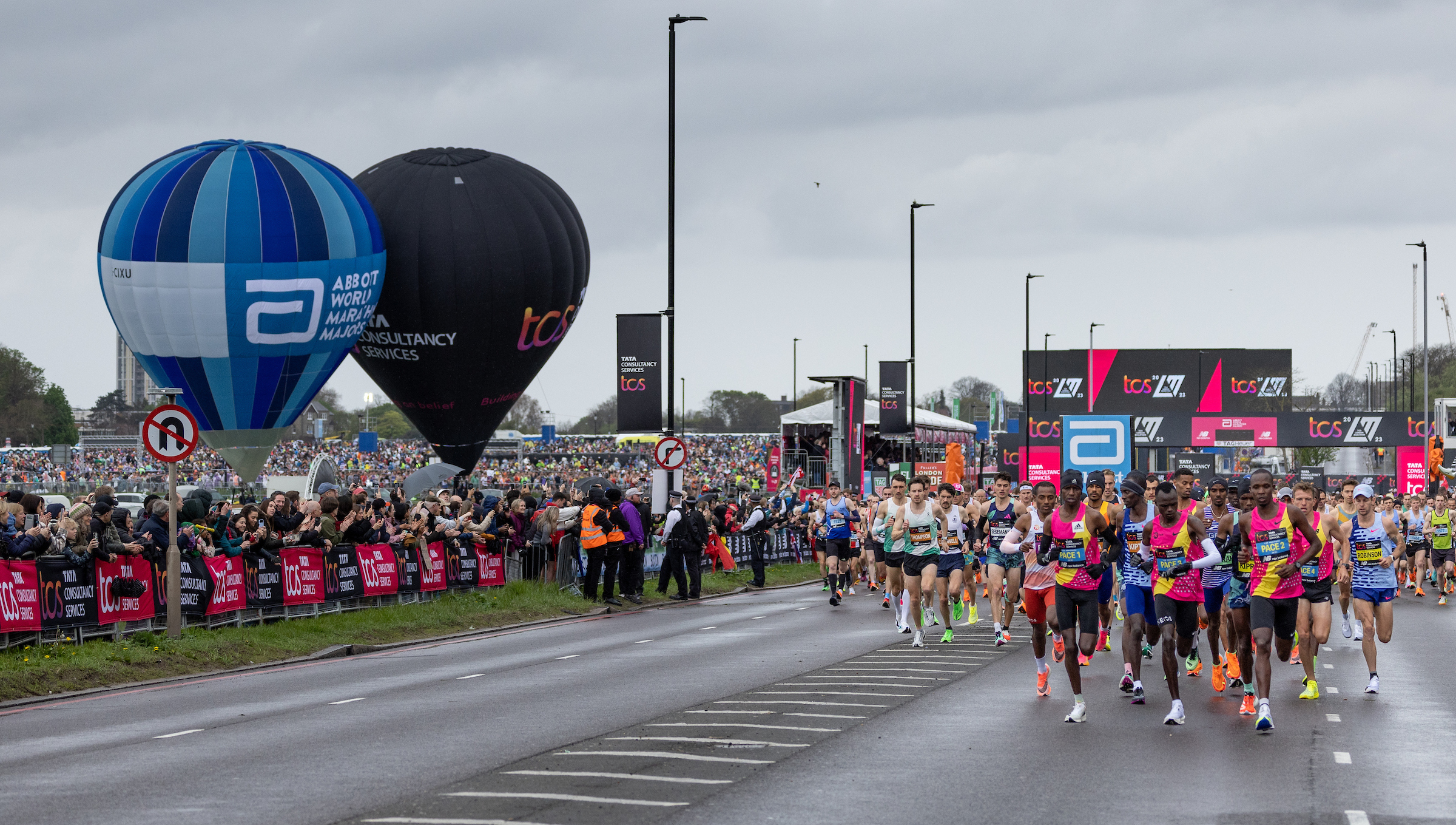 Spectators watch competitors in the Elite Men&rsquo;s race and the mass start at the beginning of the TCS London Marathon on Sunday 23rd April 2023